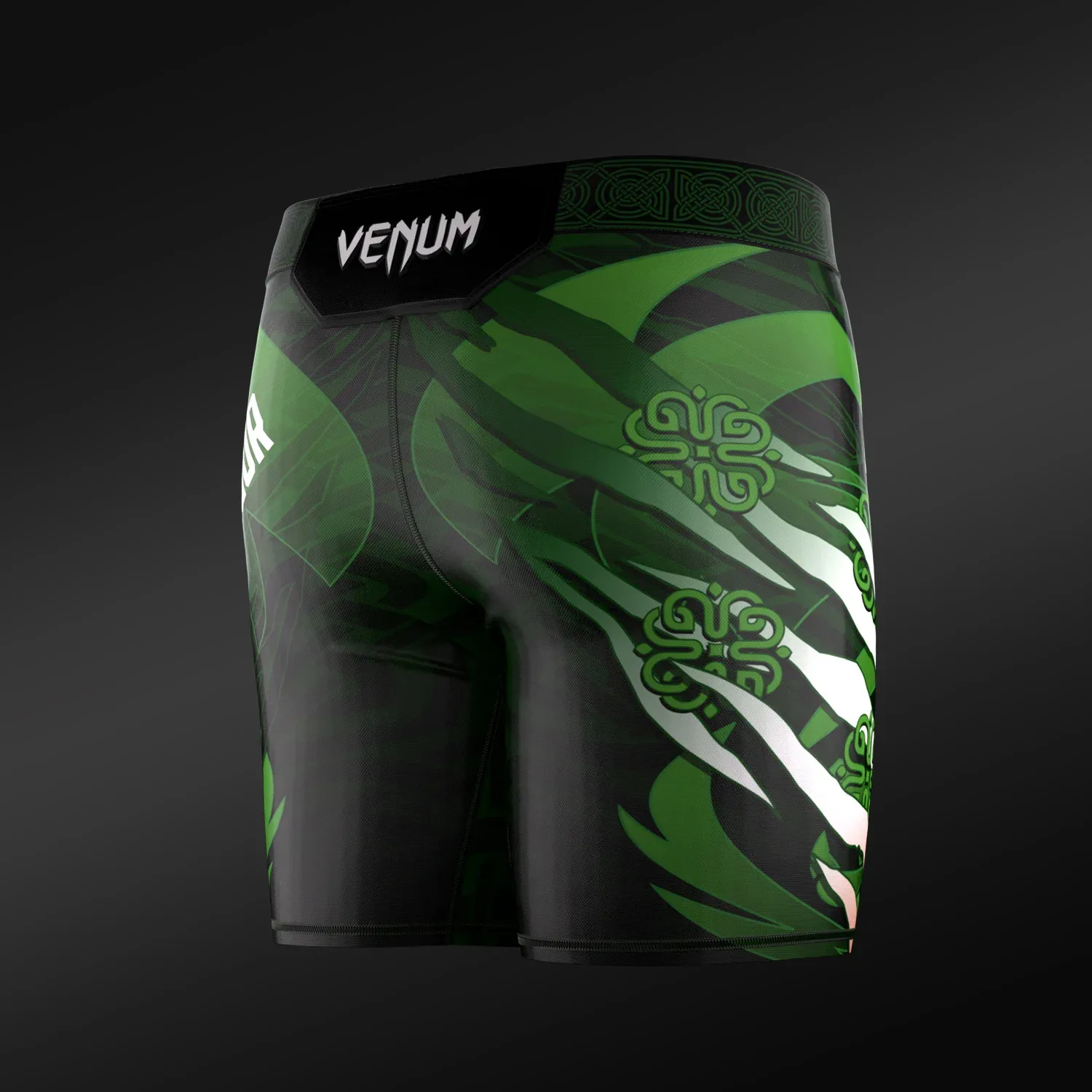 Rear view of the Conor McGregor UFC Unrivaled by Venum Vale Tudo Fight Shorts featuring Venum branding and green graphics.