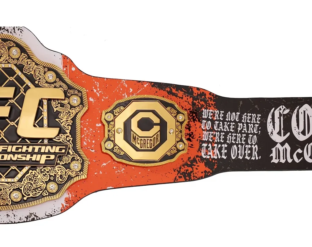 Close-up of the right strap on the Conor McGregor UFC 329 Classic Signature Replica Belt featuring signature artwork and quote.